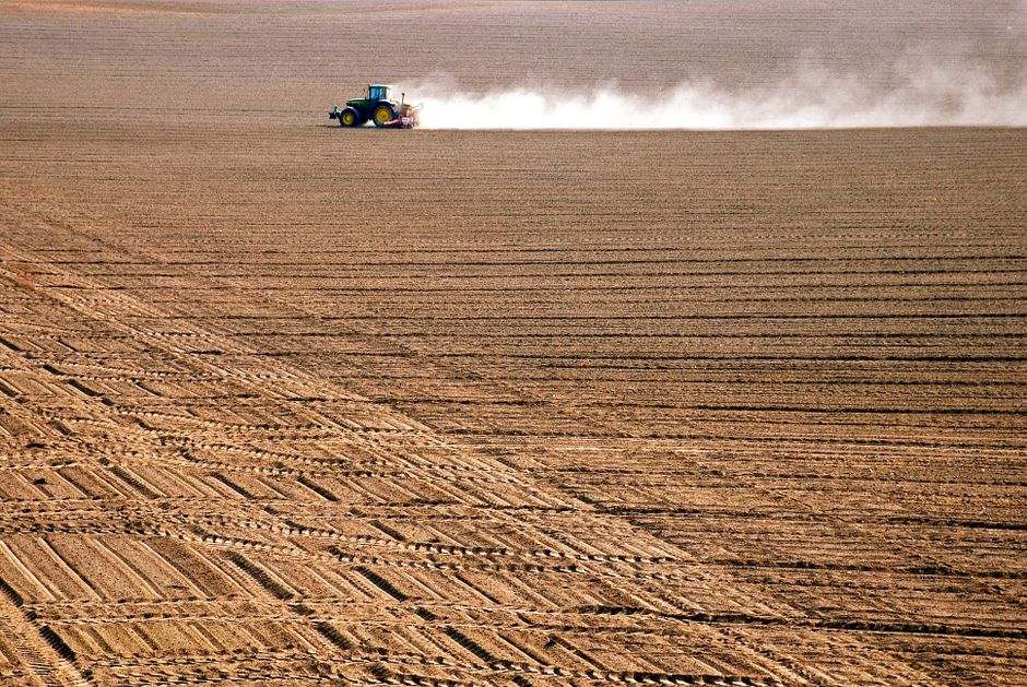 Tractor working an agricultural field